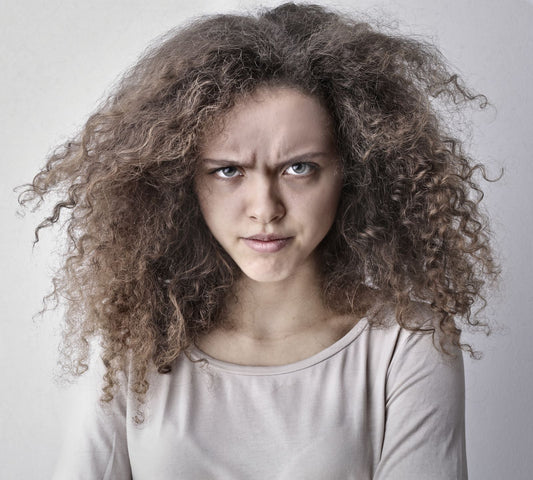 Donna che osserva capelli crespi ed elettrici